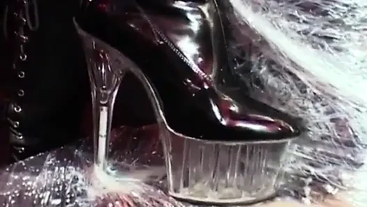 Cute filn-coated babe gets her pussy fucked by couple of strict mistresses in black