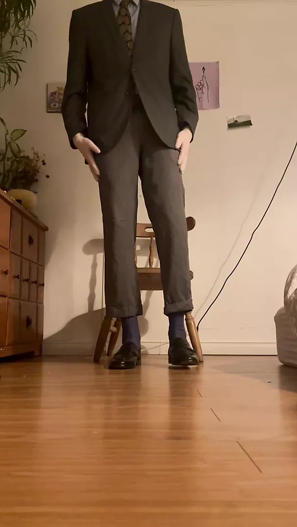 Rock hard suited guy dons white latex gloves