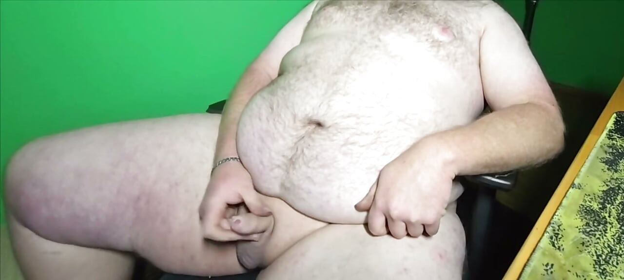 A fat boy with a small dick is masturbating.