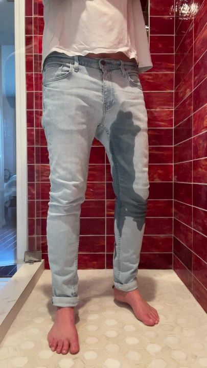 Barefoot in jeans and pissing myself. I love piss play so much