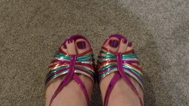 Closeup of male painted toes in rainbow heels