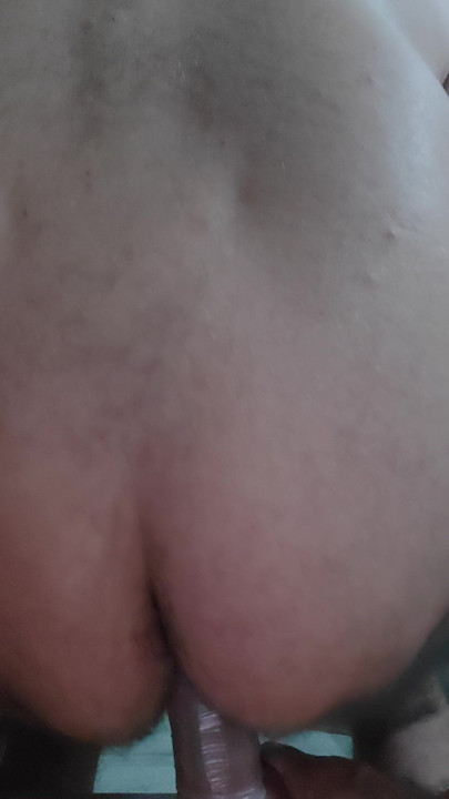 The slave sticks a big dildo in his hole