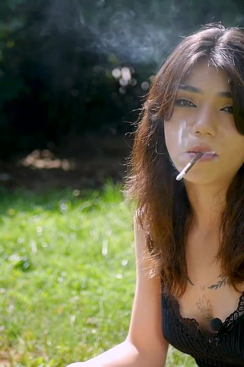 Arina Is Smoking One Black Cigarette Outdoors
