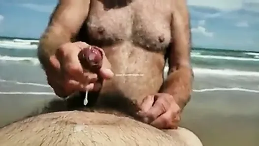 Daddy being masturbated at beach