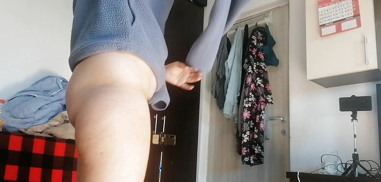 Amateur woman has fun trying on clothes and cutting them. Amateur woman vacuums naked in the house.