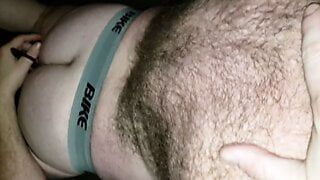 Hairy Pup wearing just jockstrap and socks swallows boys thick cock showing off his Pup tail, tight ass, and hairy back