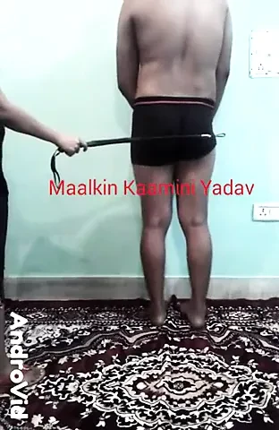 Indian Femdom Maalkin Kaamini Yadav using crop on her slave.