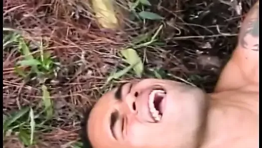 Young Latino gets drilled by a gay stud lying on a tree trun