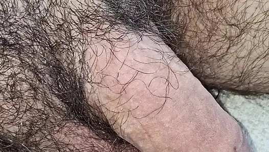 Sitting outside. With soft penis that gets hard