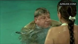 S. Grandi in white panties swimming with a guy in a 1987 movie