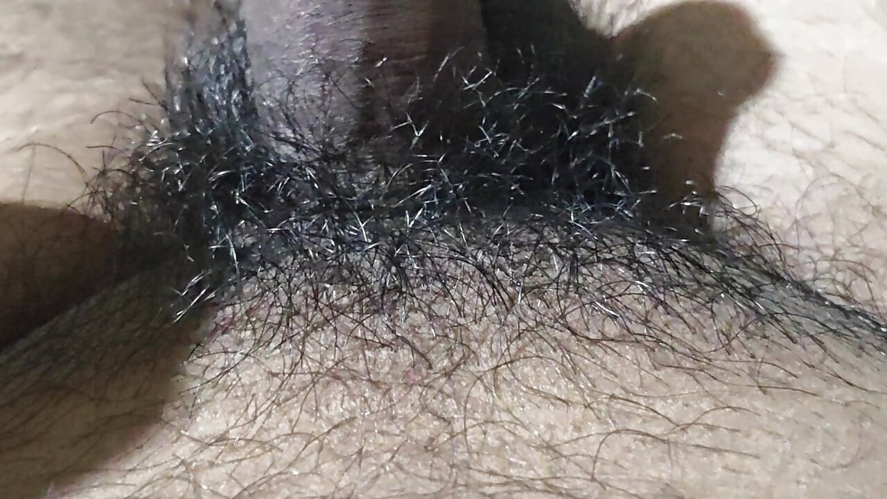 Handsome boy fingering hairy cock