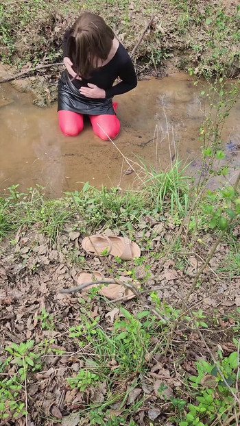 Must-see moment from "Crossdressed outdoors playing in a stream. Wearing pantyhose and miniskirt."