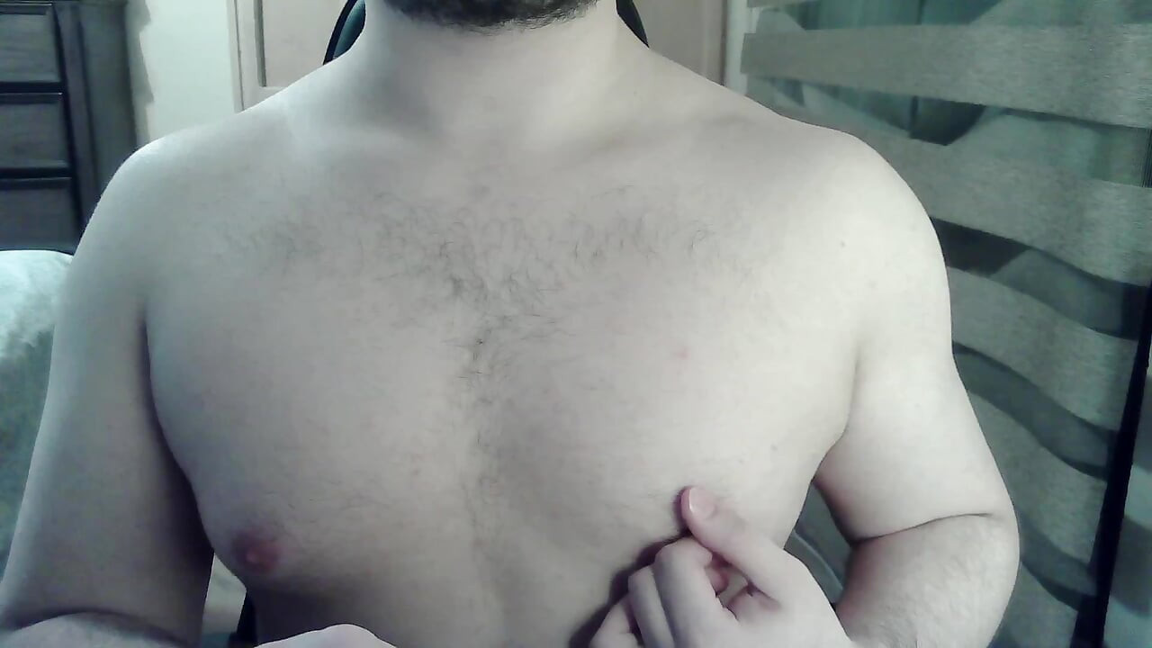 Muscular camboy flexes his muscles and squats