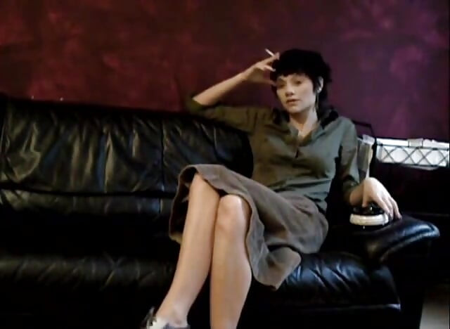Black haired teen smoking a cigarette