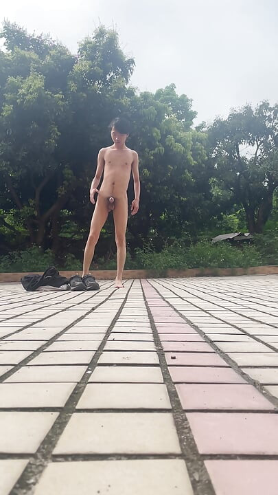 A young man publicly displays his erect penis.