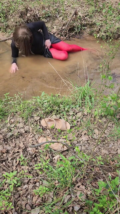 Must-see moment from "Crossdressed outdoors playing in a stream. Wearing pantyhose and miniskirt."