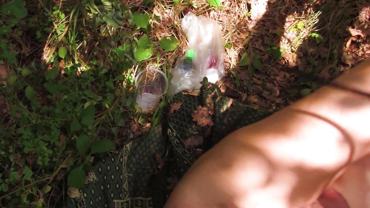 Young sadist whips an old pig tied up in the woods