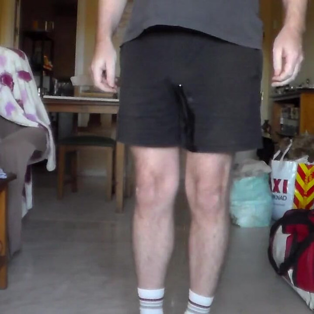 John is Peeing in his black shorts