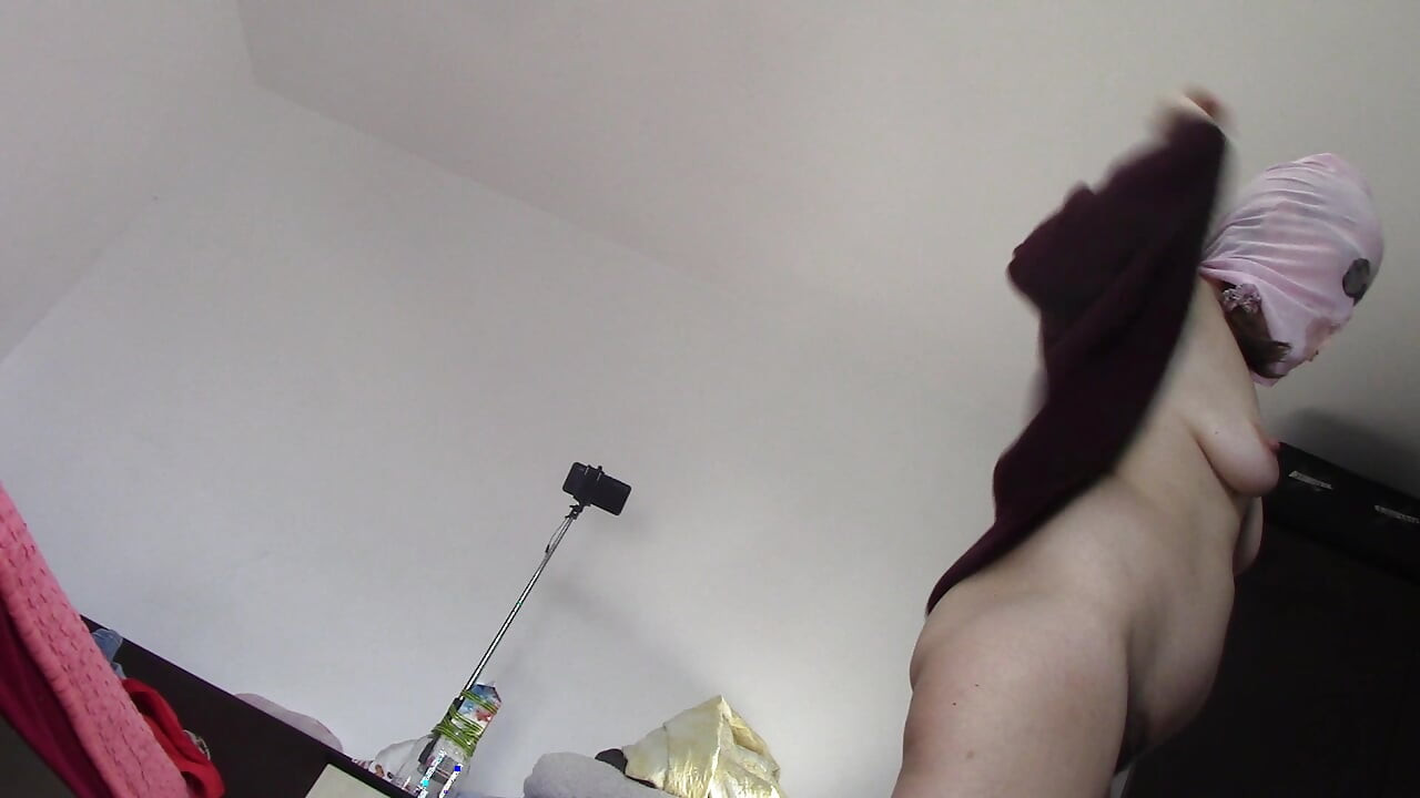 Amateur wife dancing naked at home. Amateur woman has fun trying on clothes and cutting them.
