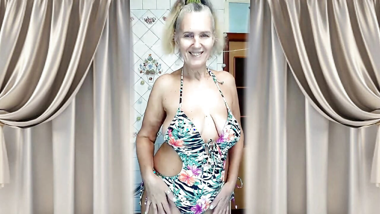 A Mature Woman Performs a Striptease in the Kitchen