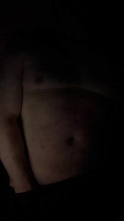 A naked man looks in the mirror.