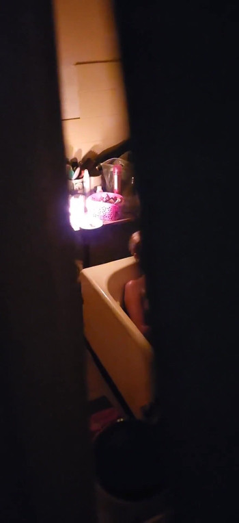 Captivating moment from "Peeping through my neighbours bathroom window,watch how she plays with her pussy"