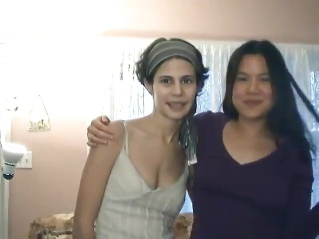 Interracial lesbians play with dildo on the living room floor