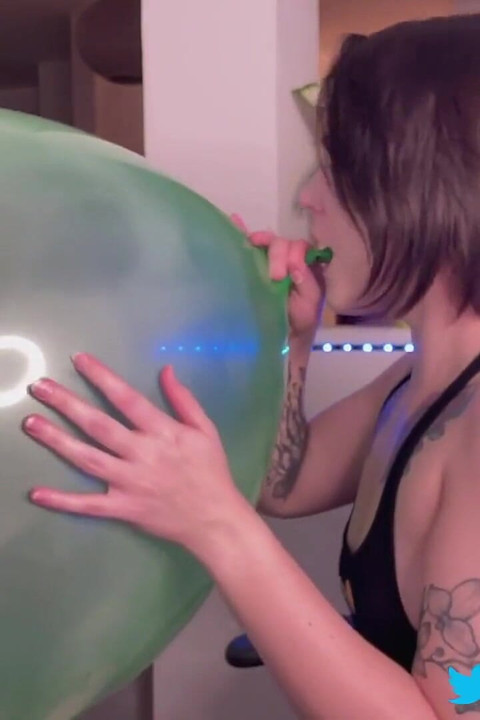 Inflating a big green balloon