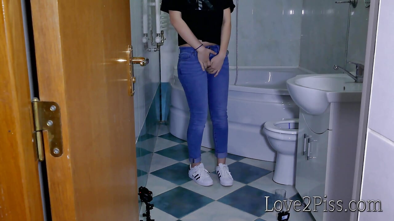 Filling a jar with her golden liquid and pipi accident in the bathroom