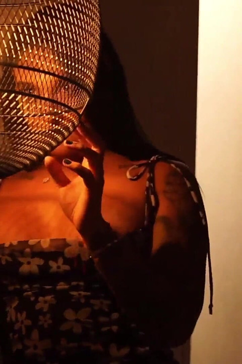 Sensual Latina Doing a Striptease in Low Light