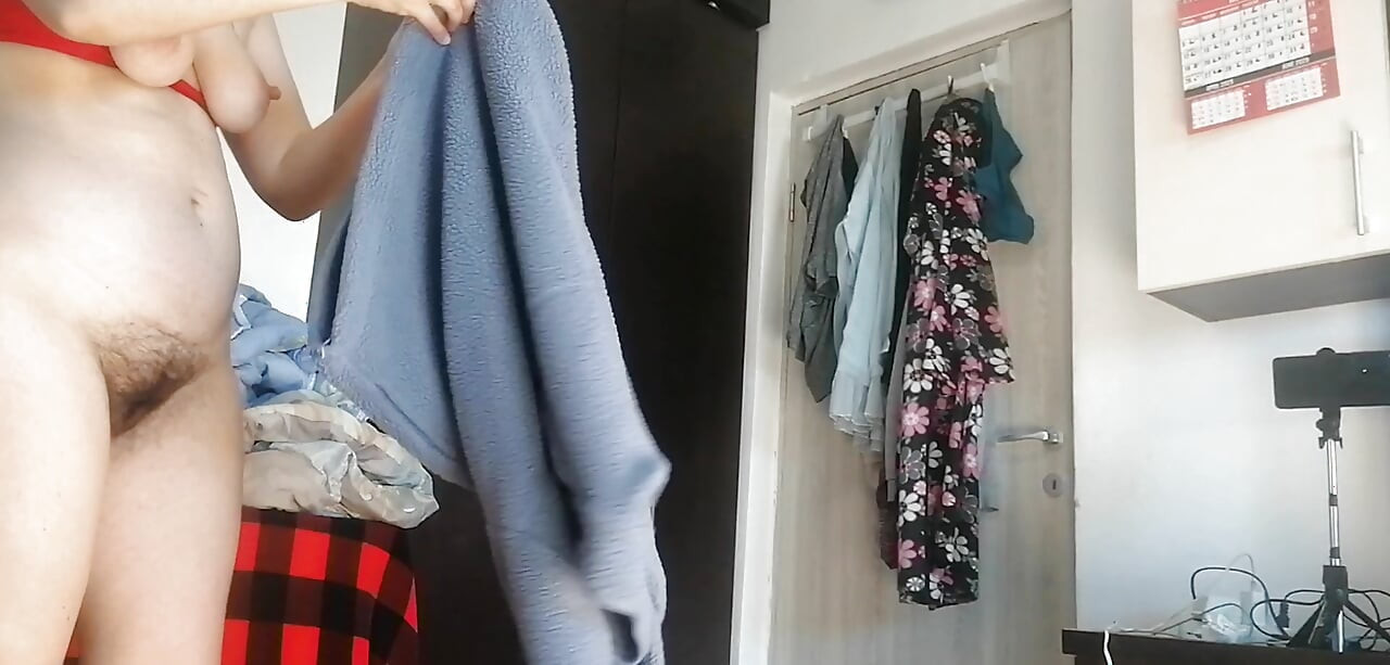 Amateur woman has fun trying on clothes and cutting them.
