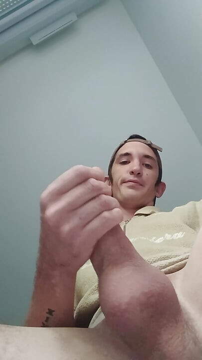Young guy jerks off his big cock and cums