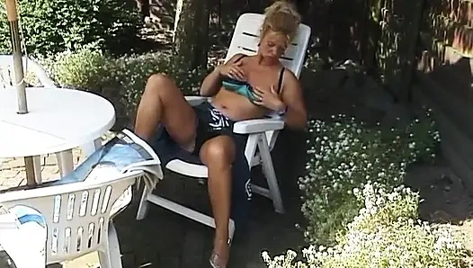 Blonde milf showing off her boobs outdoors