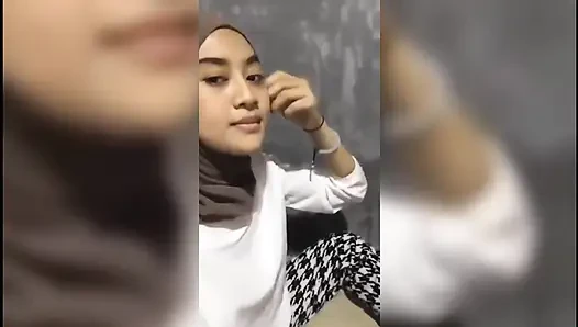 Beautiful girl who is squeezing her breasts alone