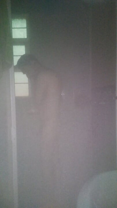Man Showering with Flashlight On