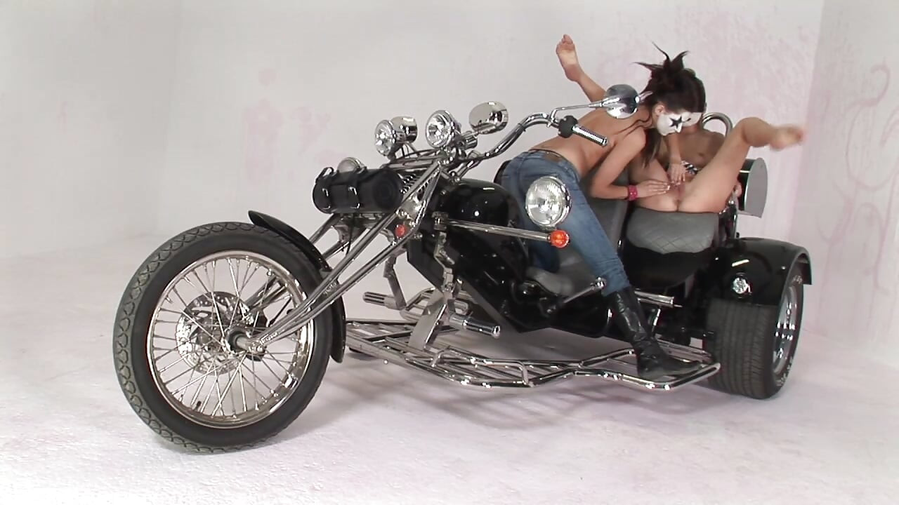 Lesbian Moto Riders with Painted Faces Licking Pussy and Playing with a Dildo
