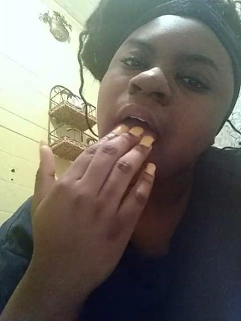 Sucking her fingers