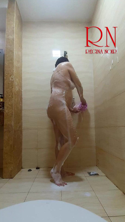 Her peaceful shower routine gets a playful twist as her husband watches from behind the camera. Regina Noir.