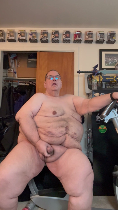 Old fat man masterbating on exercise bike