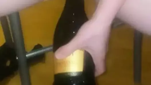 Women using wine bottle as a dildo