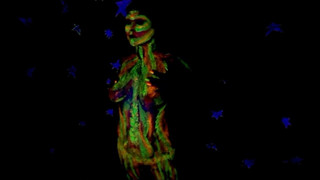 Glowing paint at night on a naked body.