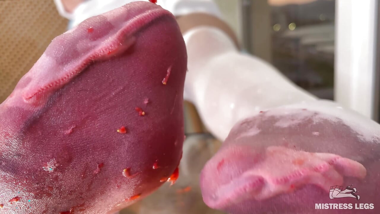 My Nylon Feet Squeezing Strawberry Juice on a Glass Table