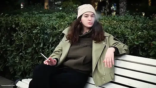 Young Brunette Is Taking an Unhurried Stroll with Allwhite 120mm Cigarette