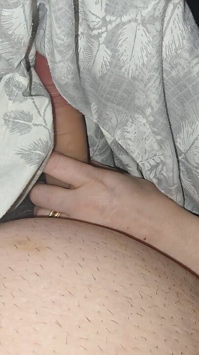 Step sister surprises step brother with a handjob while they watch a movie