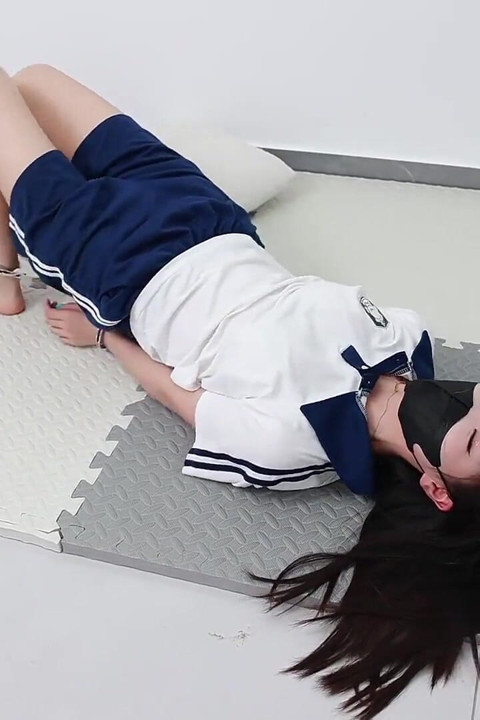 In a Couples' Game, the Girlfriend Must Pick up Coins Under the Constraints of Handcuffs and Shackles