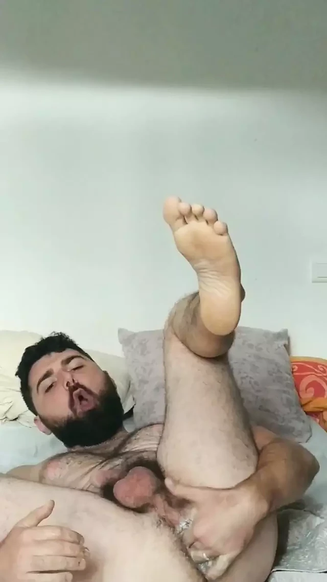 Hairy guy fingering his asshole