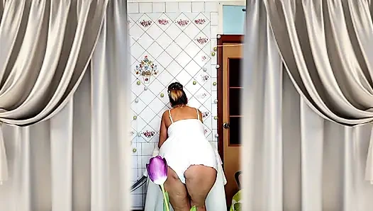 Mature housewife Lukerya twerks her curvy figure in white shorts in the kitchen, hot flirting and teasing movements