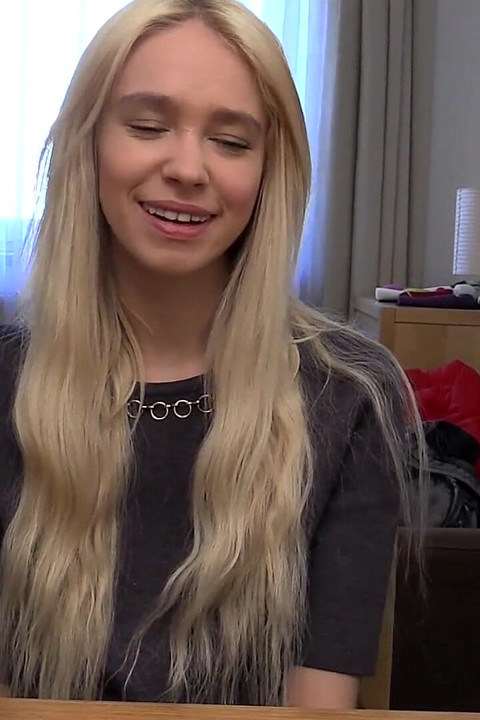 Blonde Babe Grips Purple Vibrator with Naughty Smile