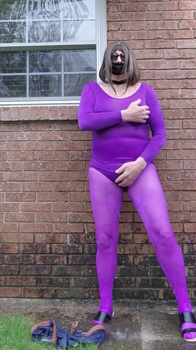 Stunning moment from "Crossdressed outdoors in nylon bodysuit getting wet in the rain."