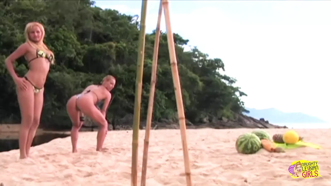 After partying on a beach these blondes use a big sex toy on each other